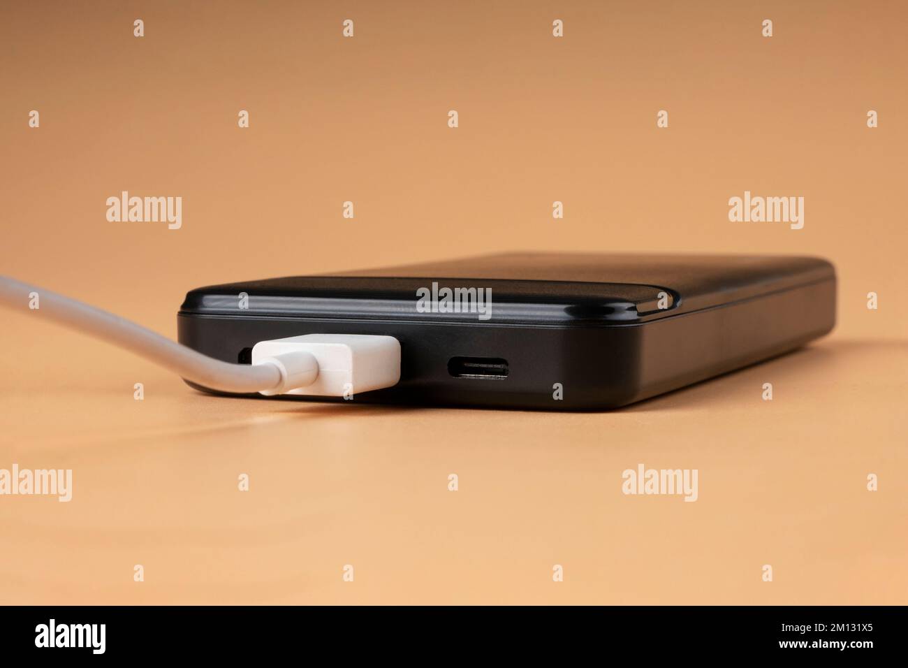 Schwarzes Telefon wird über usb aufgeladen. Stockfoto
