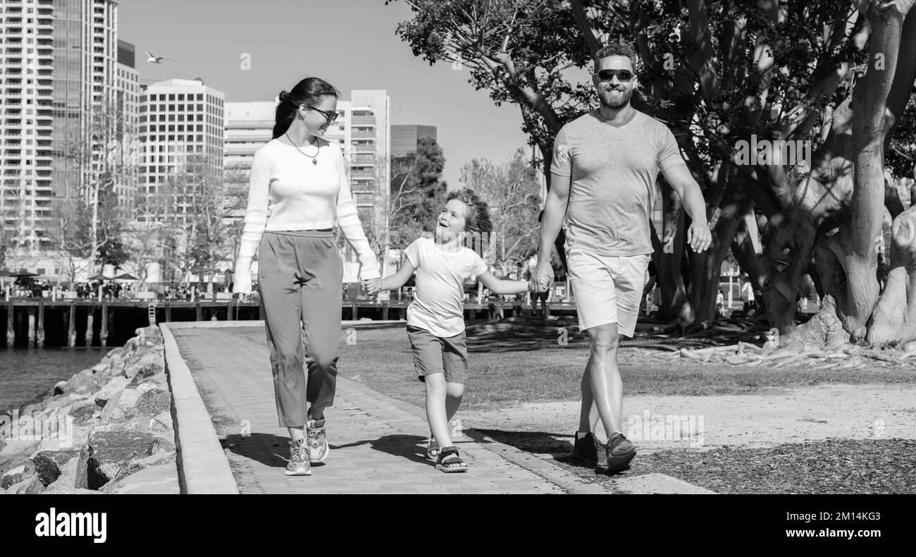 Glückliche junge Mutter und Papa zu Fuß im Park mit Sohn, Nächstenliebe Stockfoto