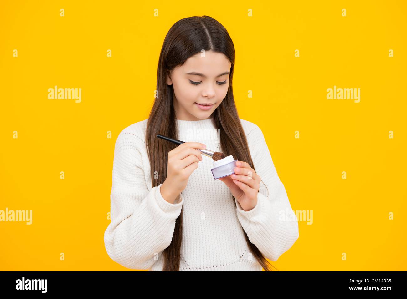 Kinder machen Produkte. Make-up teen Kind Künstler gelten Gesichtspuder mit Make-up Pinsel. Schönheit und Kosmetik für Jugendliche. Stockfoto