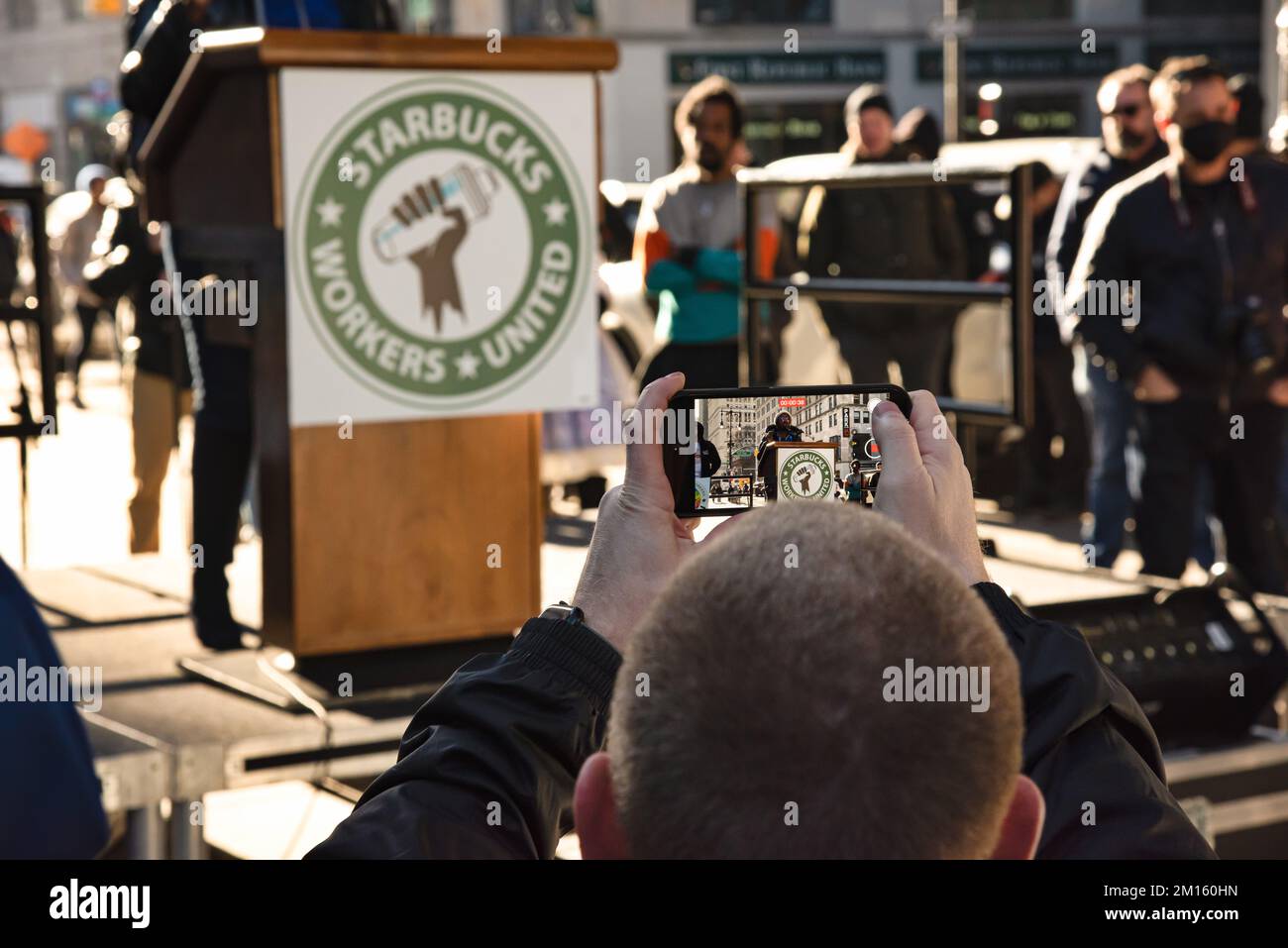 9. Dezember 2022, New York City, New York, USA: Ein Gewerkschaftsmitarbeiter von Starbucks nimmt einen Redner bei der Kundgebung auf, um zu fordern, dass Howard Schultz, CEO von Starbucks und das Unternehmen, die Gewerkschaft anerkennt, die sich um ihre Mitarbeiter bemüht, und ihre Mobbing-Taktik, ihre Bemühungen zu zerschlagen, zu beenden. (Kreditbild: © Laura Brett/ZUMA Press Wire) Stockfoto