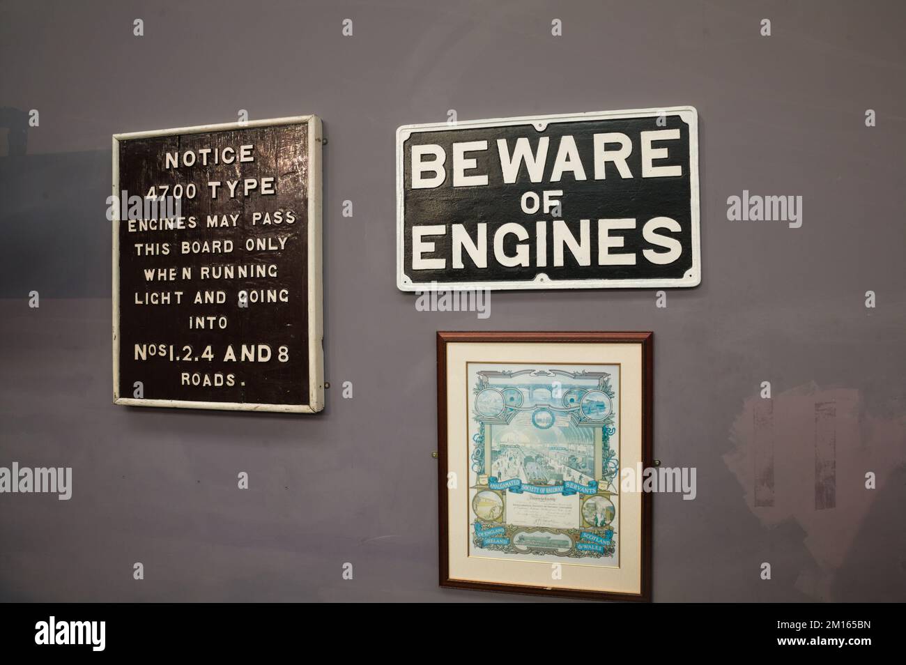 Warnhinweise und Zertifikat an der Wand im Swindon Dampfeisenbahnmuseum Stockfoto