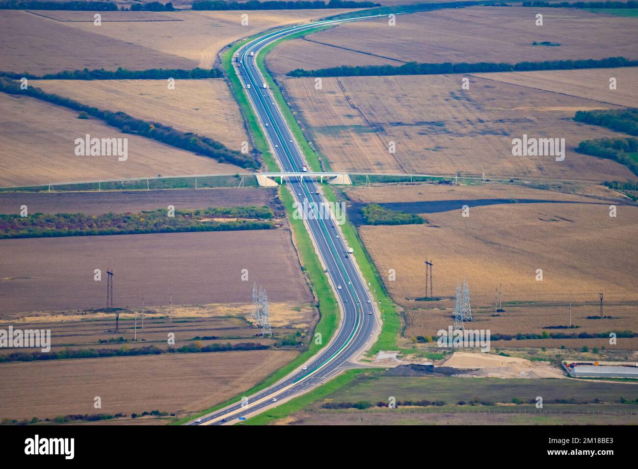 Die Autobahn in der Mitte der Steppe. Blick von oben. Eine schöne Kurve auf der Straße. Stockfoto