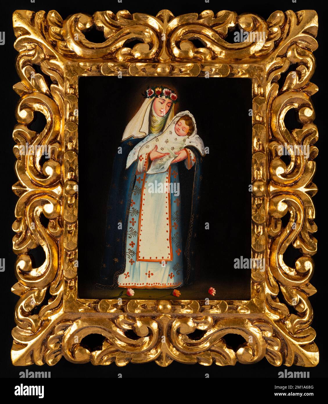 Symbolgemälde, die die heilige Rose von Lima mit dem Kind Jesus darstellen. Römisch-katholische Hingabe in einem goldenen kunstvoll verzierten Rahmen. Stockfoto