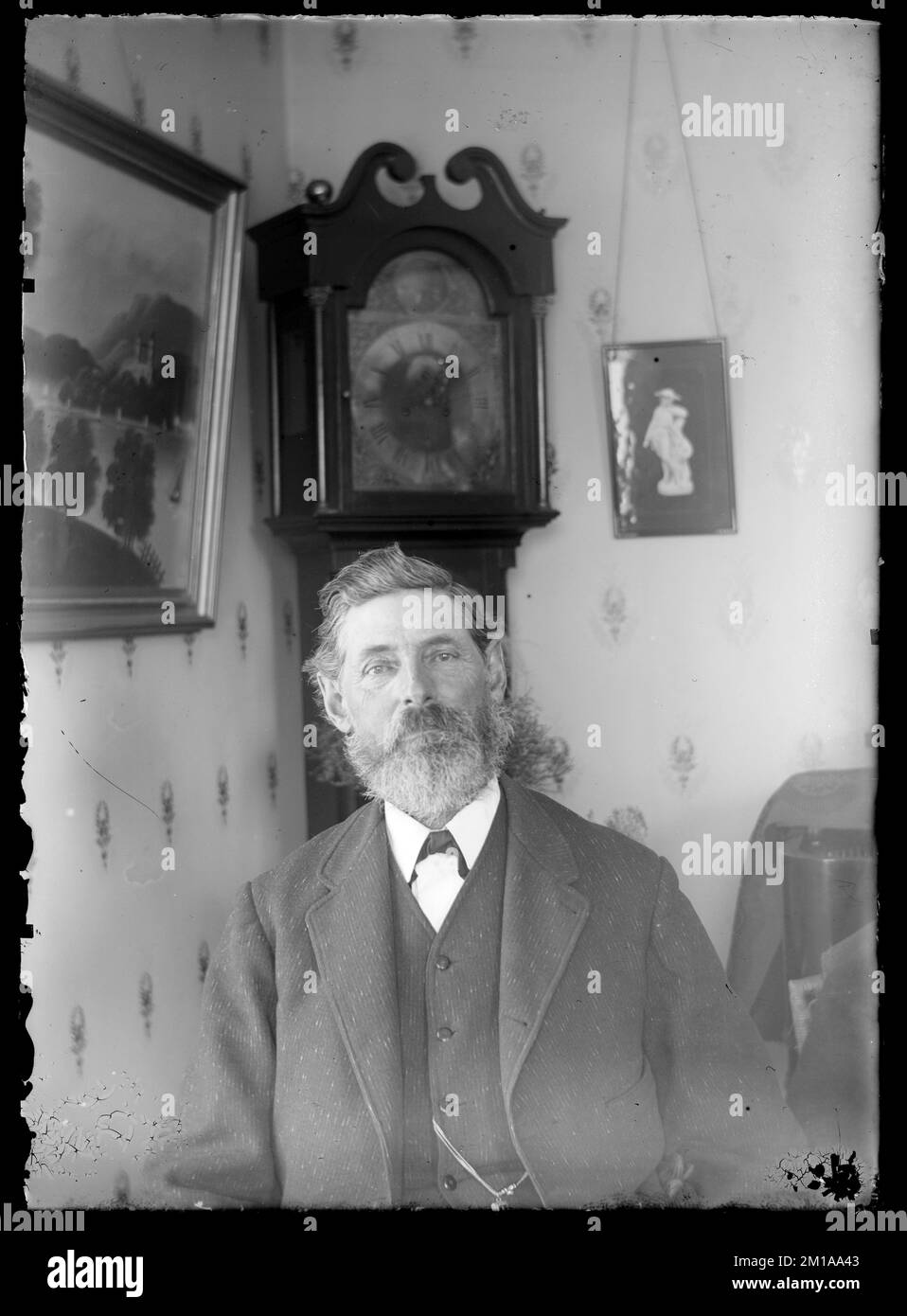 Unidentifizierter Mann, der vor Großvater Ccok sitzt, Leute. Hingham Public Library Glass Slide Kollektion Stockfoto