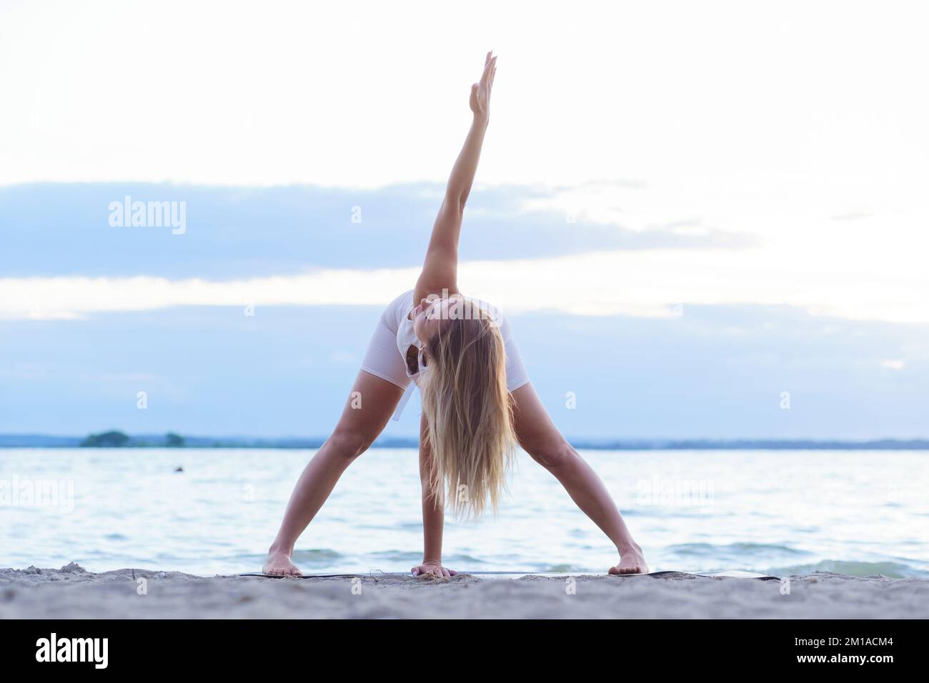 Junge Frau, die am Ufer des Sees Sport macht. Stockfoto