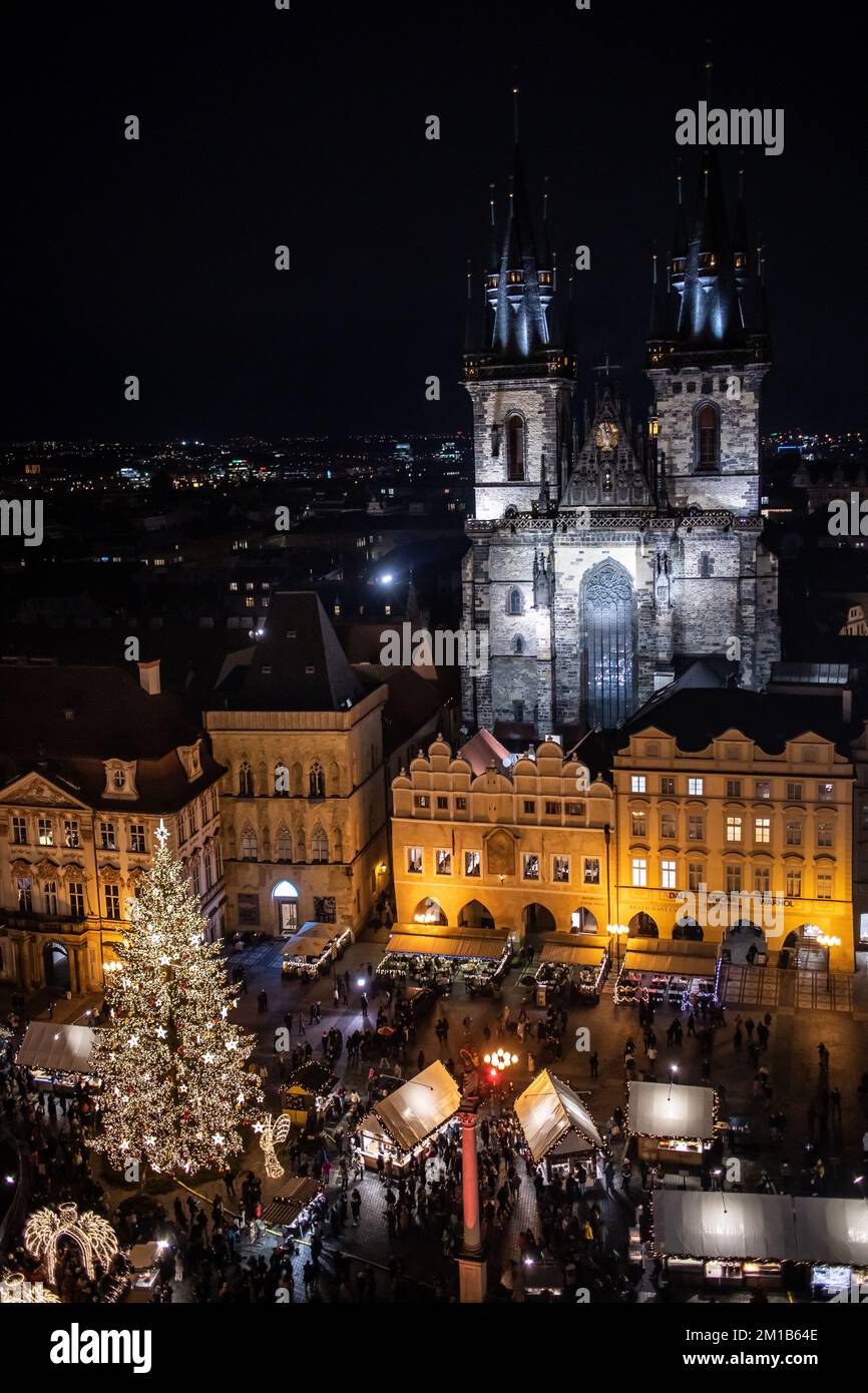 Prag, Tschechische Republik - 5. Dezember 2022: Dark Top View of Christmas Market at Old Town Square. Über der Festivalstadt mit dem Wahrzeichen der gotischen Kirche. Stockfoto