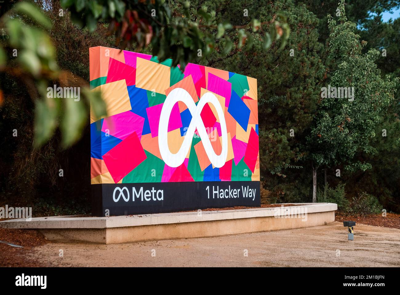 Reklametafel mit Meta-Logo und farbenfrohen Designs mit 1-Hacker-Text Stockfoto