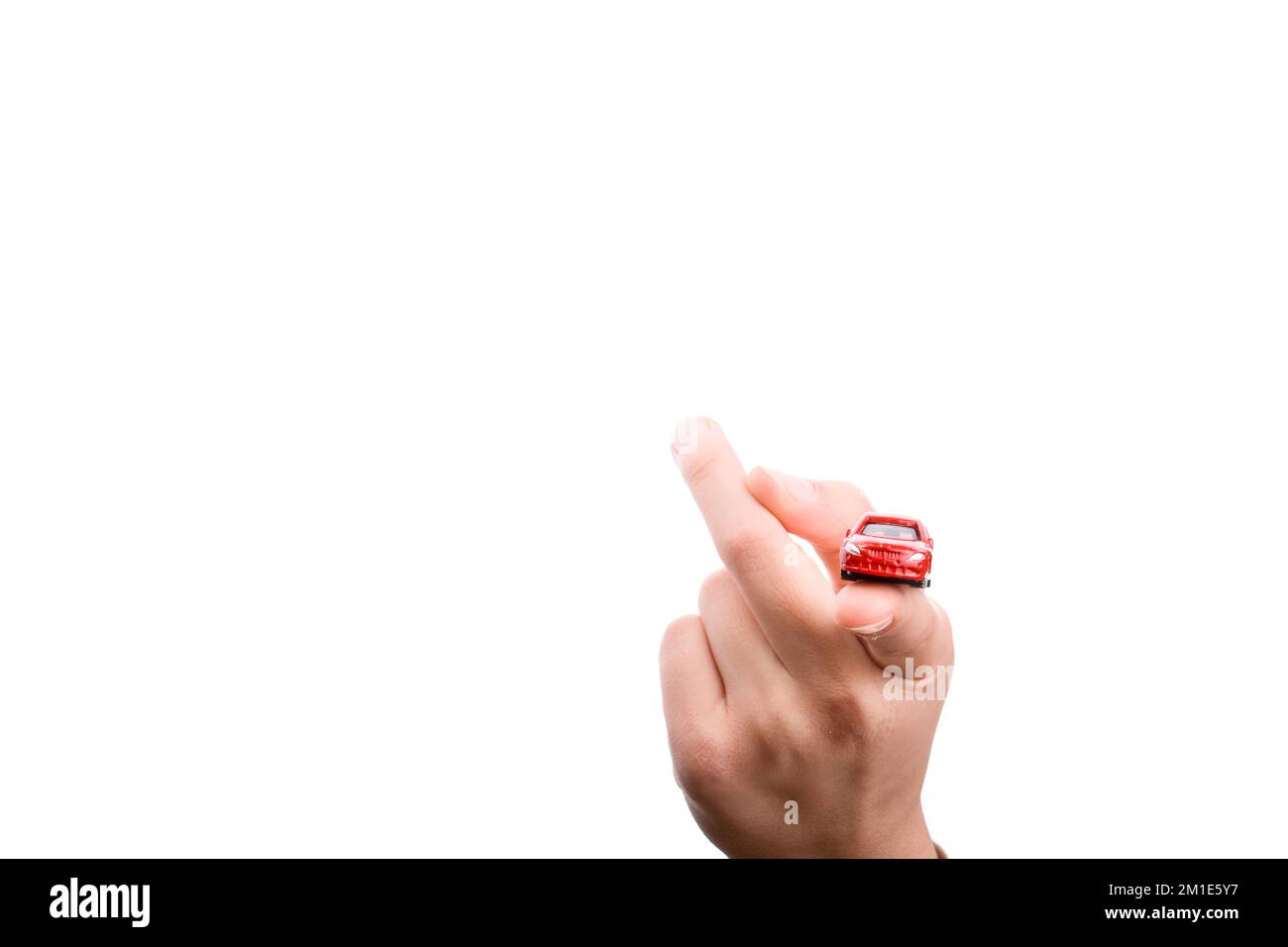 Des Kindes Hand hält ein rotes Auto auf weißem Hintergrund Stockfoto