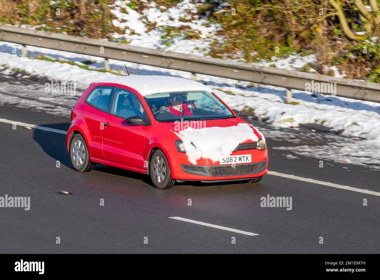 2012 Red VW Volkswagen POLO S 60 1198cc 5-Gang-Schaltgetriebe; Autos, die an einem kalten Wintermorgen unterwegs sind. Winter niedrige Temperaturen mit Frost im Dezember und kalte Fahrbedingungen auf der Autobahn M61, Großbritannien Stockfoto
