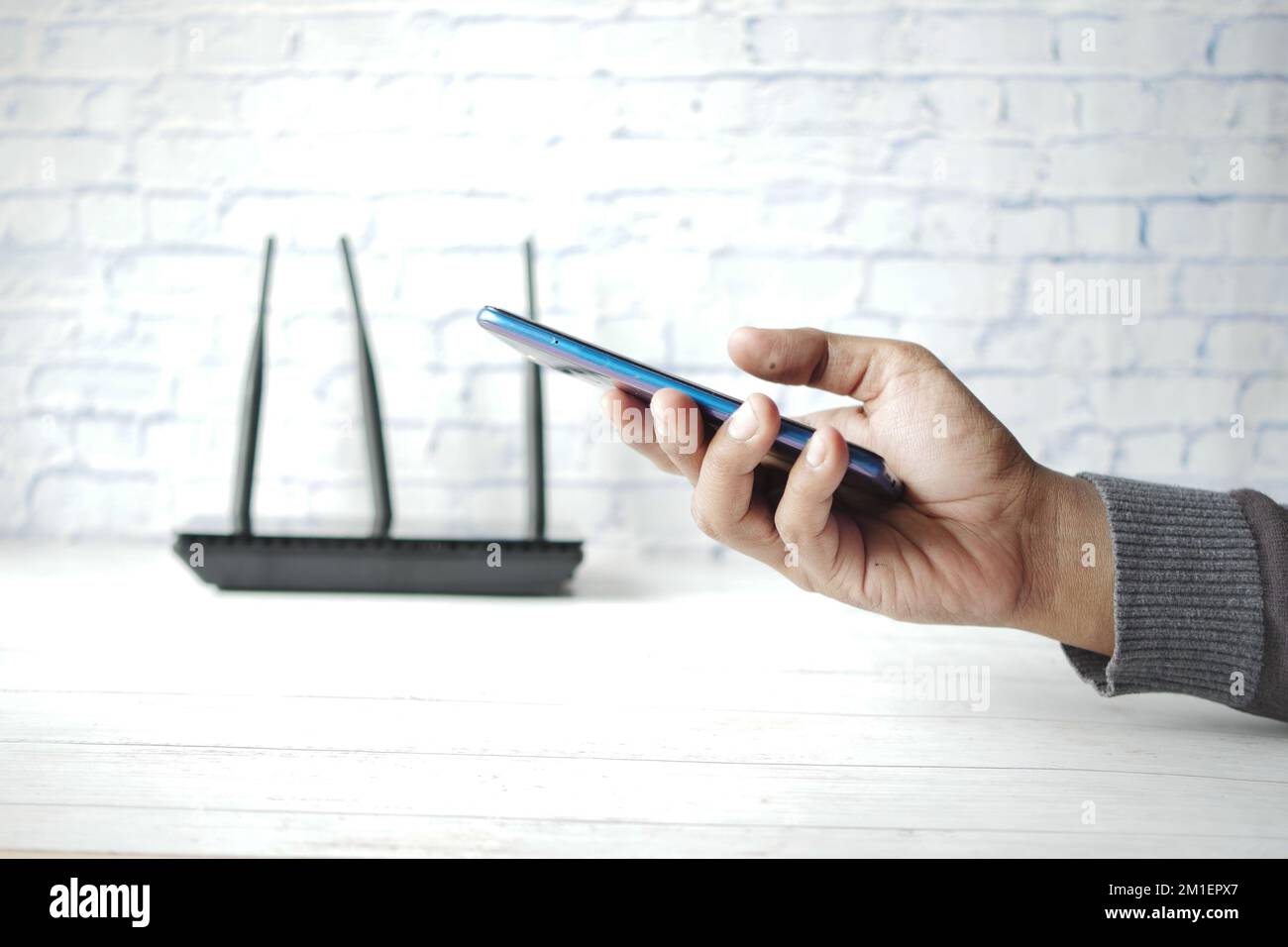 Wi-Fi Wireless Internet und Hand halten Smartphone auf dem Tisch Stockfoto