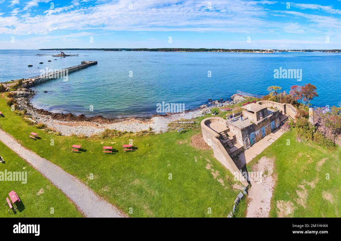 Alte Militärfestung an der Küste von Maine mit Pier und kleinem Leuchtturm der Insel in der Ferne Stockfoto