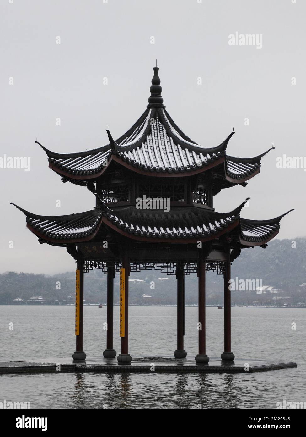 Ein vertikaler Blick auf den Pavillon am Westsee, umgeben von Hügeln während des Tages in Hangzhou, Ostchina Stockfoto