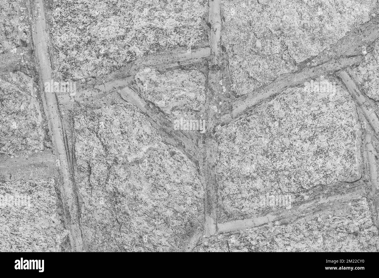 Grau hellgrauer Stein Kopfsteinpflaster Wandstruktur Gesteinsmuster abstrakter Hintergrund. Stockfoto