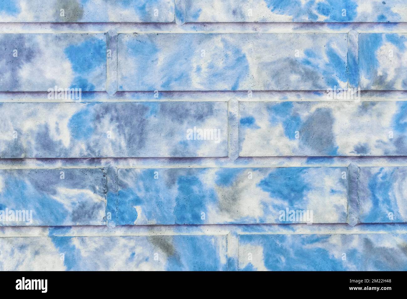 Dekorativer Ziegelsteinzaun abstraktes blaues gepunktetes Farbmuster moderner Hintergrund für Innenwände. Stockfoto