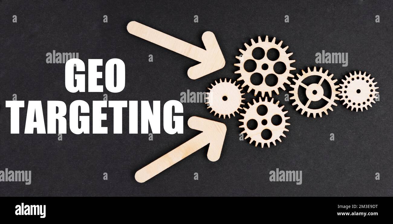 Geschäfts- und Finanzkonzept. Auf der schwarzen Oberfläche, mit Pfeilen, Zahnrädern und einer Aufschrift - GEO-TARGETING Stockfoto