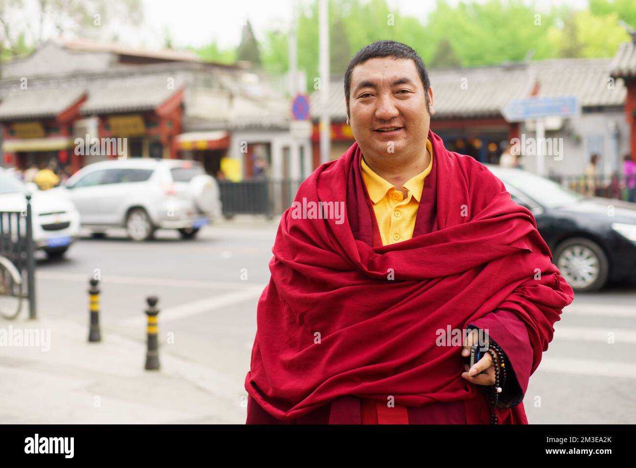 PEKING- APRIL 28: Unidentifizierter Mönch, der am 2013. April in Peking, China, auf der Straße posiert. Buddhistische Schulen unterscheiden sich in der genauen Natur des Weges zur Libera Stockfoto