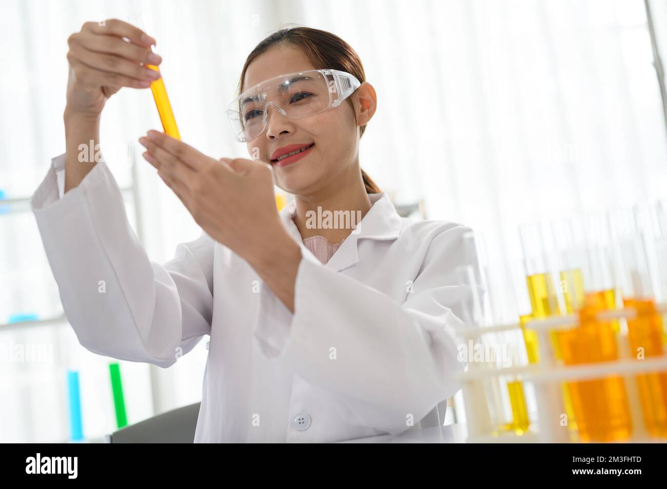 Nahaufnahme der Hände von Laborassistenten, die das Reagenzglas mit Ölflüssigkeit halten Stockfoto