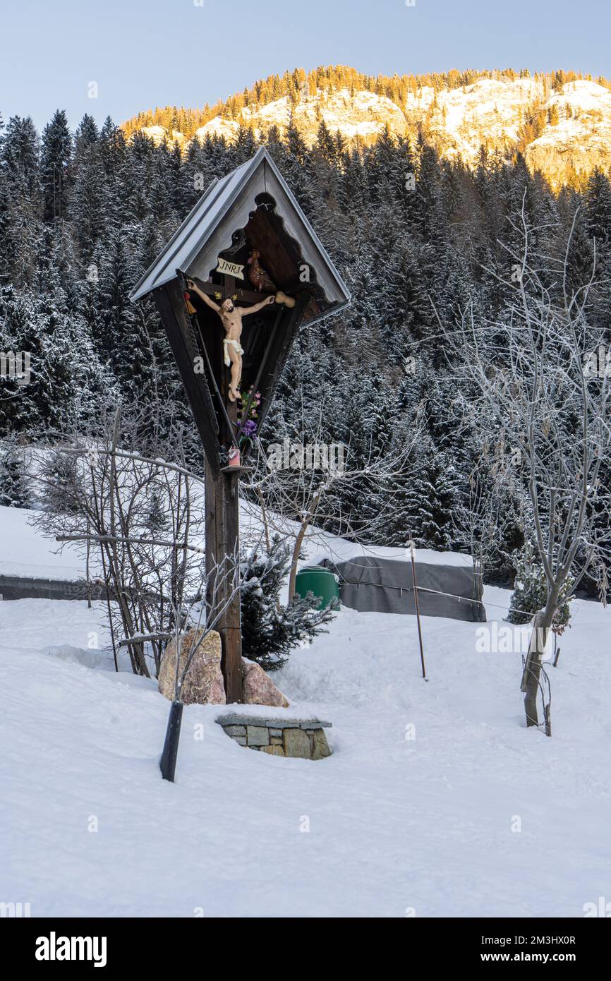 Ein hölzernes Kruzifix in einer verschneiten Landschaft Stockfoto