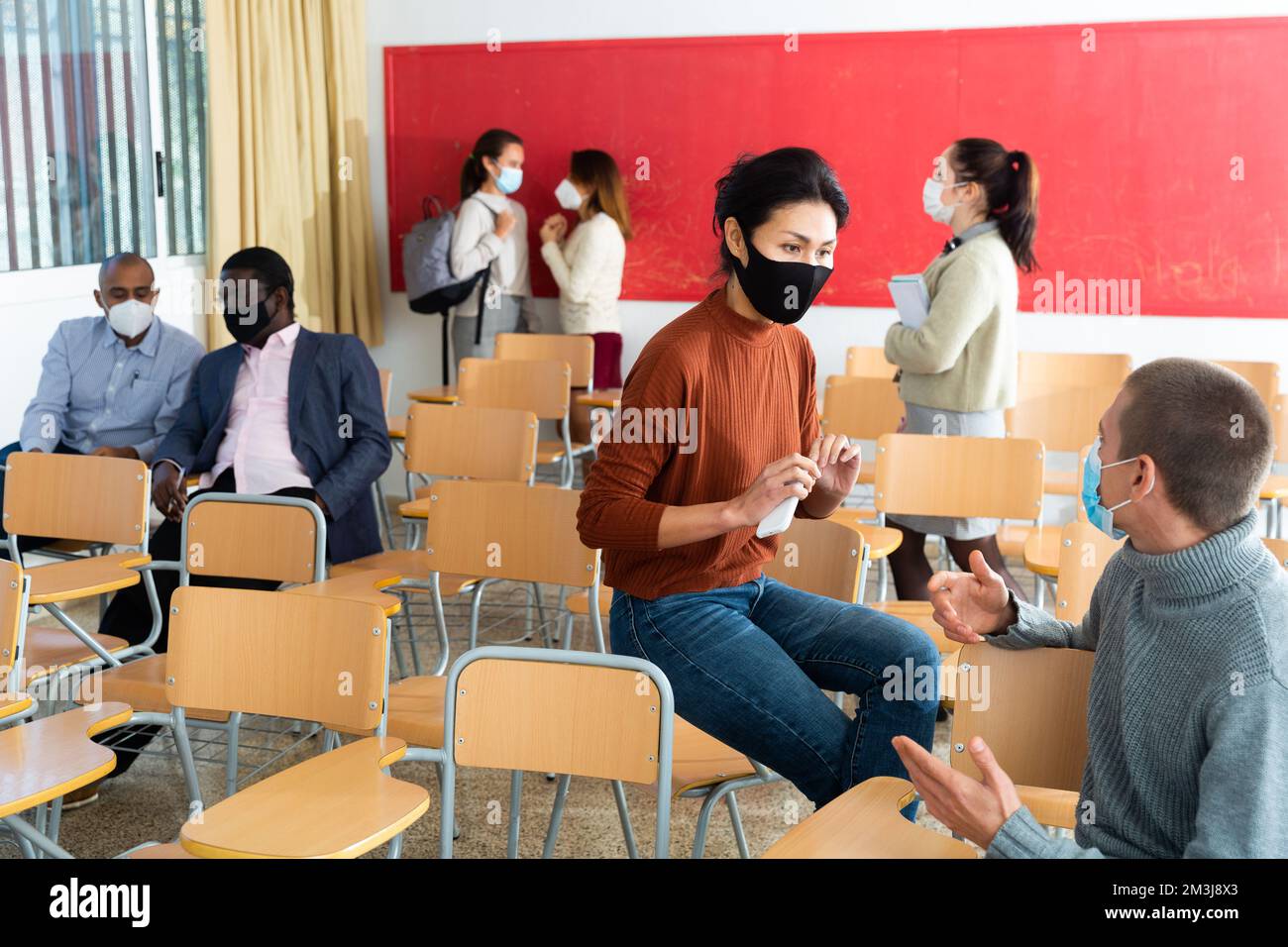 Schüler tragen im Klassenzimmer eine Schutzmaske Stockfoto