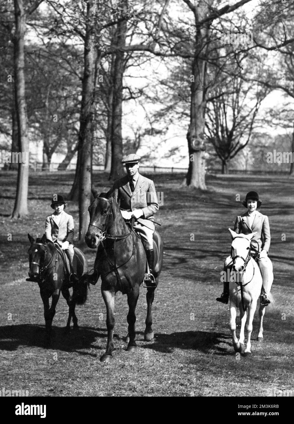 Foto der Königin Elizabeth, als Prinzessin Elizabeth mit ihrem Vater, König George VI. (1895-1952) und ihrer Schwester Prinzessin Margaret (1930-2002) anlässlich ihres dreizehnten Geburtstages im Windsor Great Park saß. Datum: 1939 Stockfoto