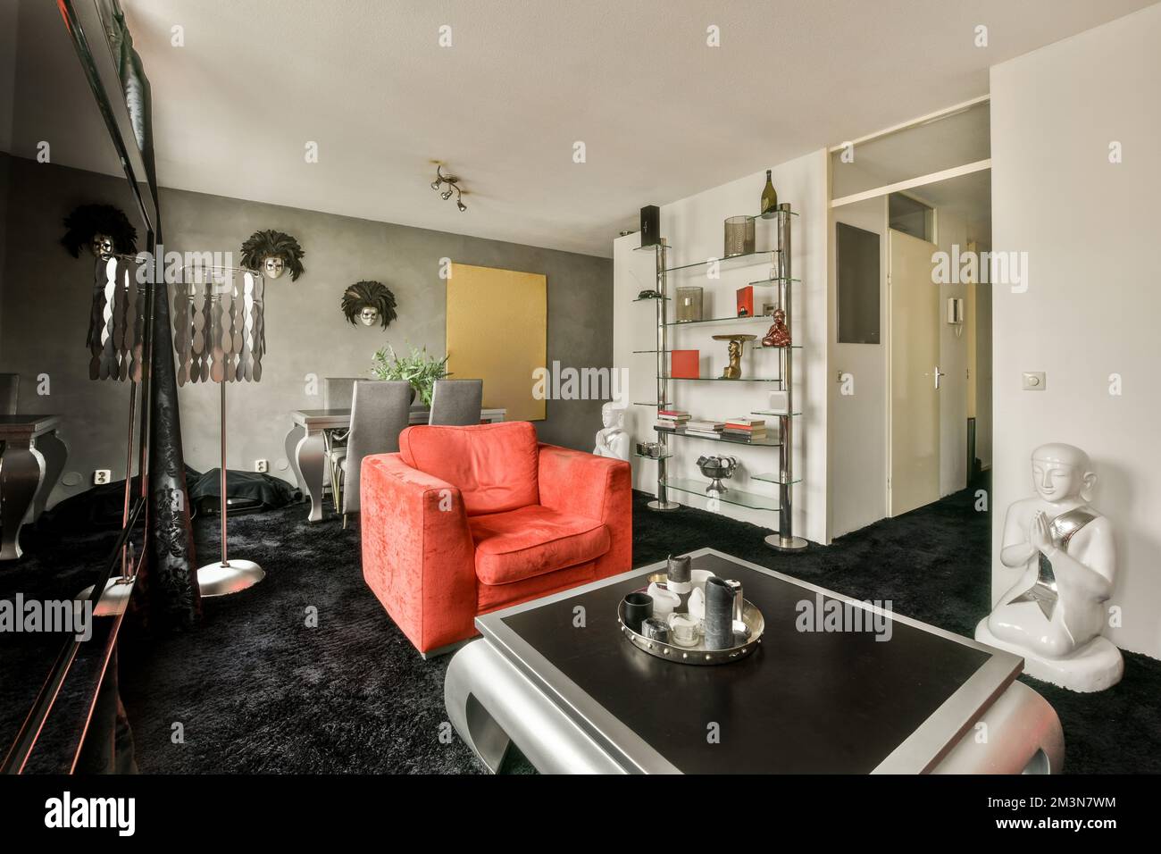 Wohnzimmer mit komfortablem rotem Sofa und Fernseher gegen Fenster im modernen Apartment Stockfoto