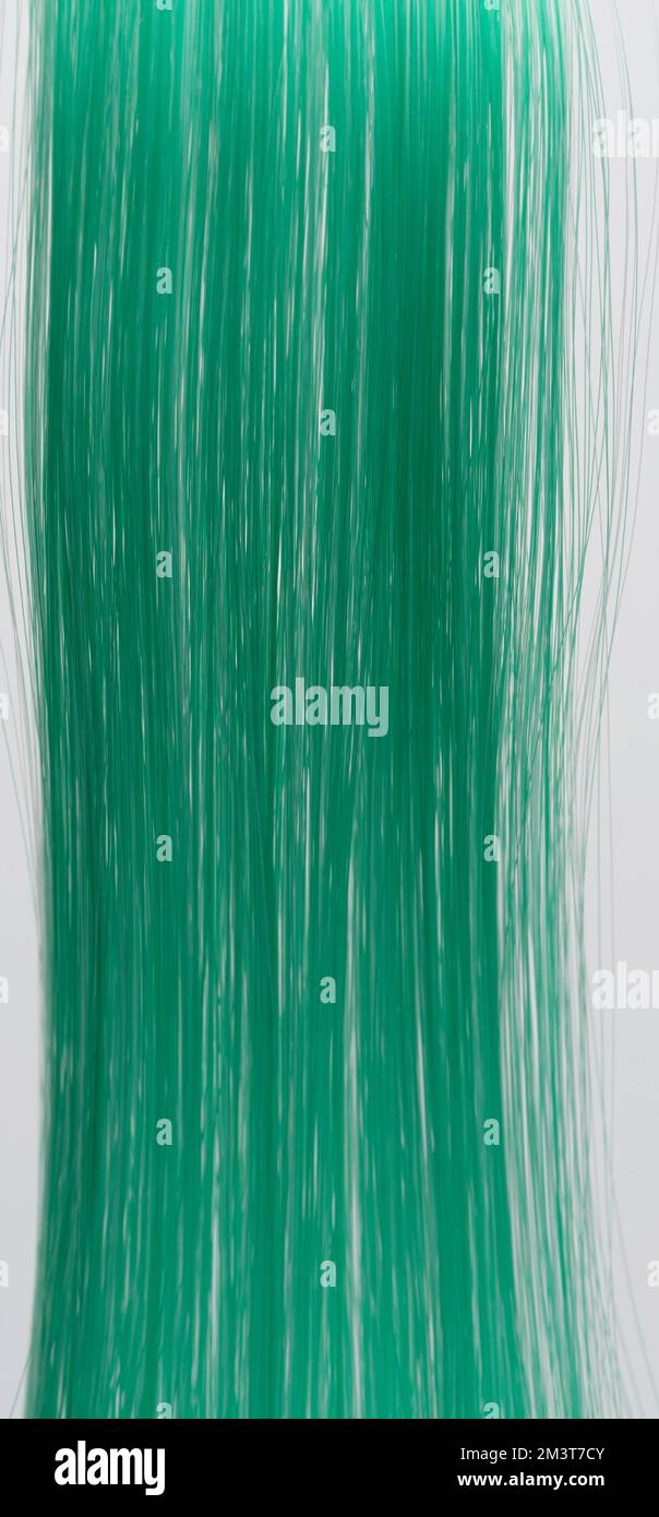 Grünes, langes, gerades Haar im Hintergrund, Makro-Nahaufnahme Stockfoto
