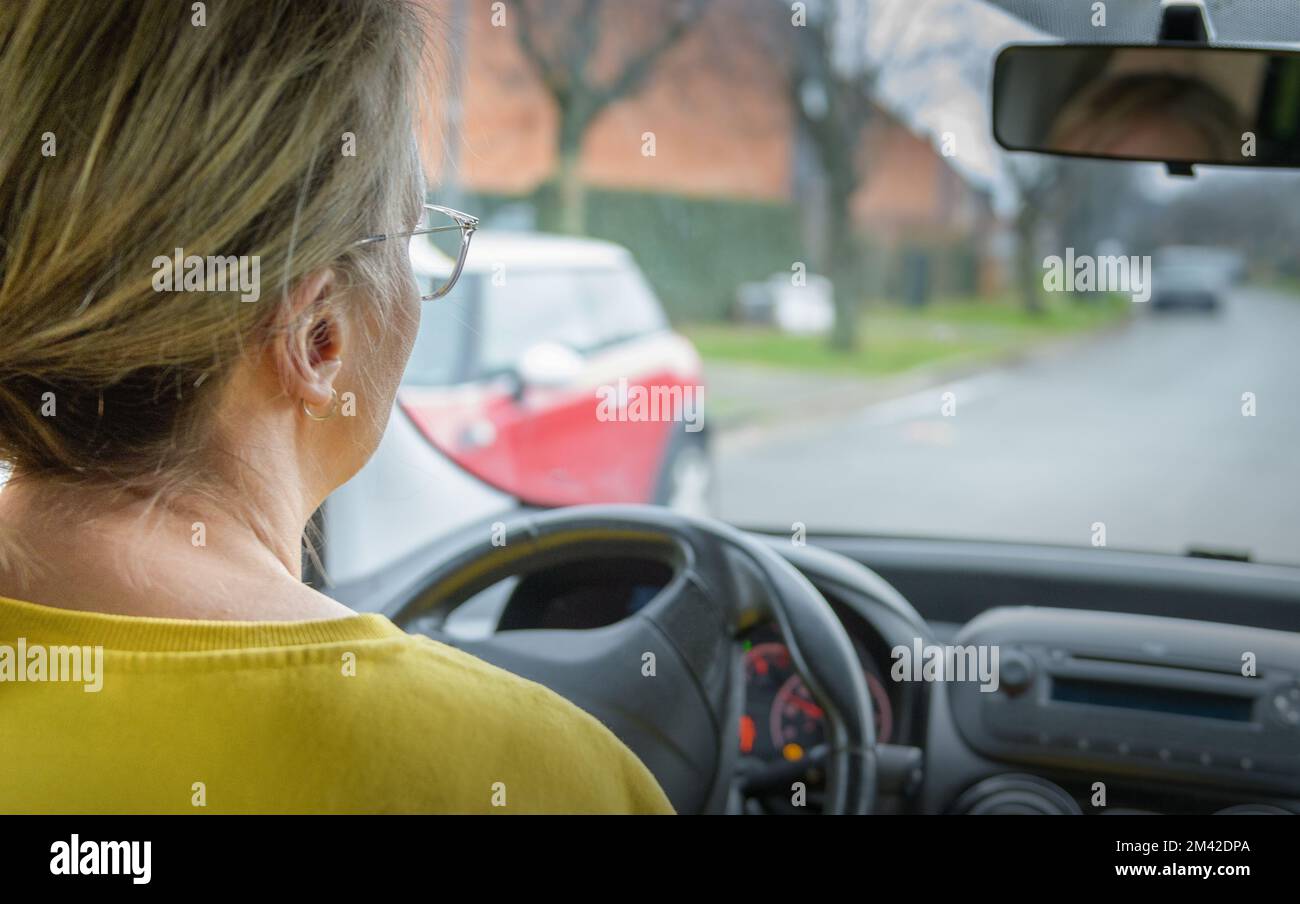 Frau, die Auto fährt, Blick von hinten. Straßenperspektive Stockfoto