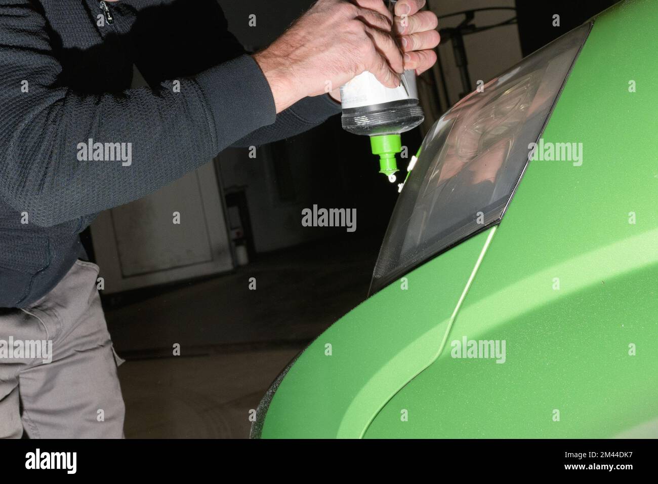 Polieren von Autoscheinwerfern. Auftragen einer speziellen Paste zur Reinigung von Scheinwerfern an einem Auto Stockfoto