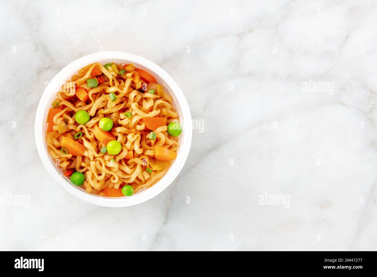 Ramen-Tasse, Instant-Soba-Nudeln in einem Plastikbecher mit Gemüse, von oben mit einem Platz für Text geschossen Stockfoto