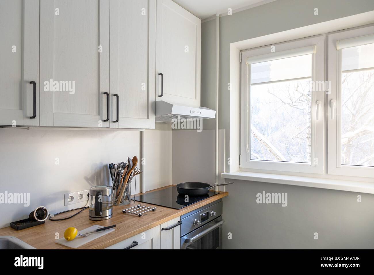 Moderne, kleine, helle Kücheneinrichtung bei Tageslicht Stockfoto