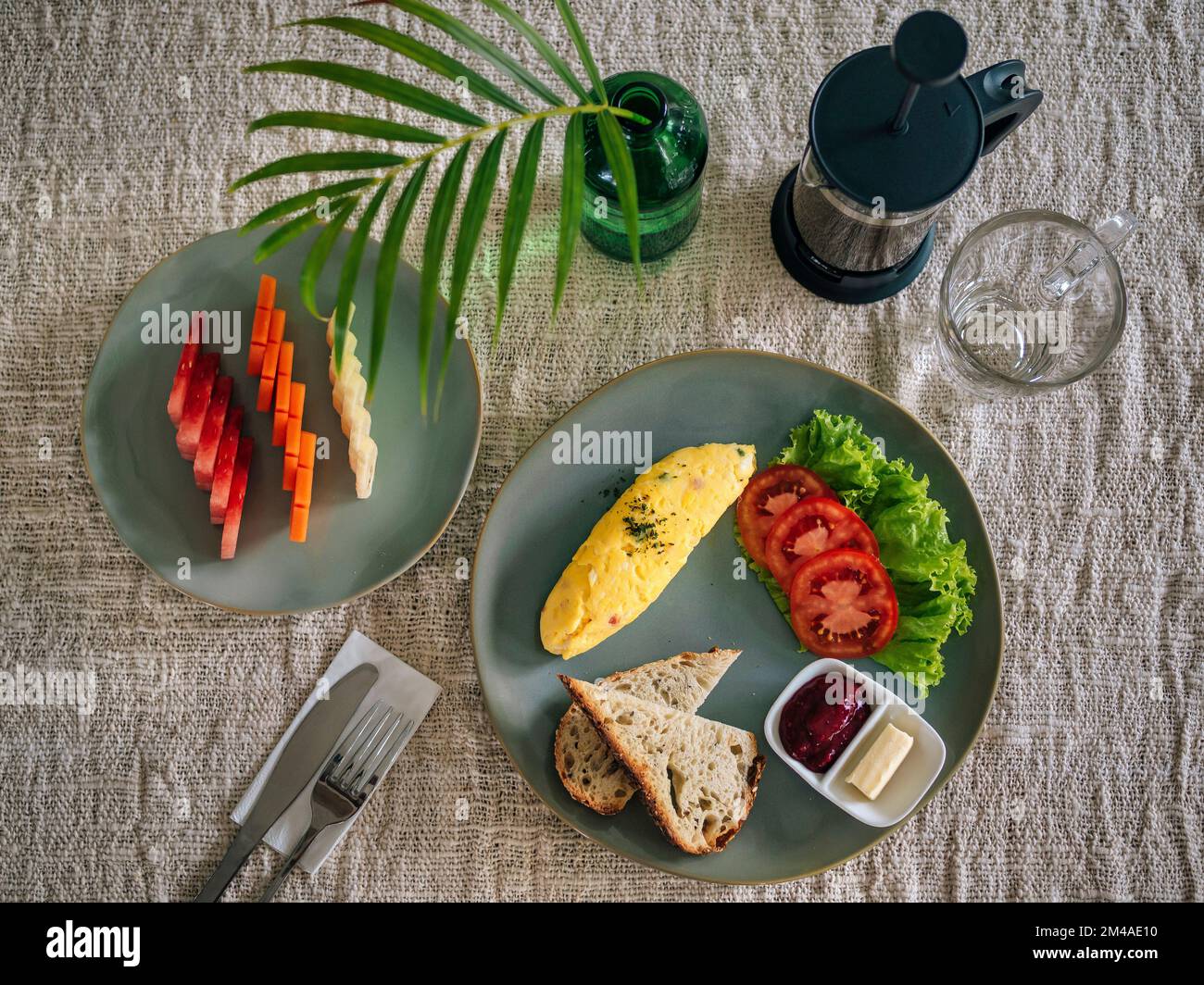 Köstliches Omelette mit Tomaten und Obst auf dem Tisch Stockfoto