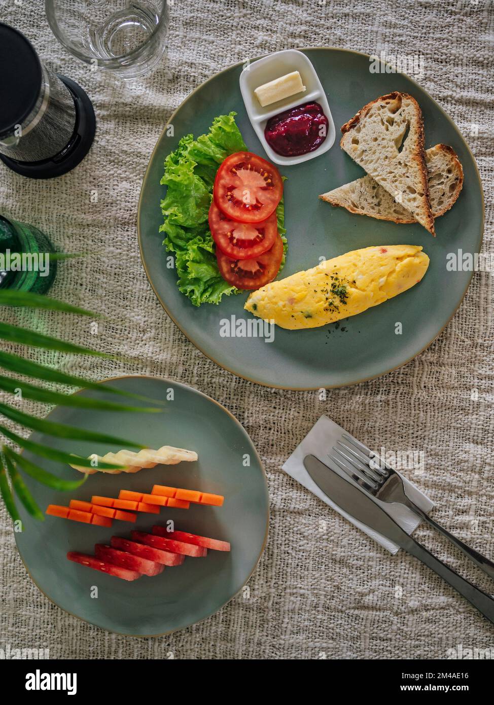 Köstliches Omelette mit Tomaten und Obst auf dem Tisch Stockfoto