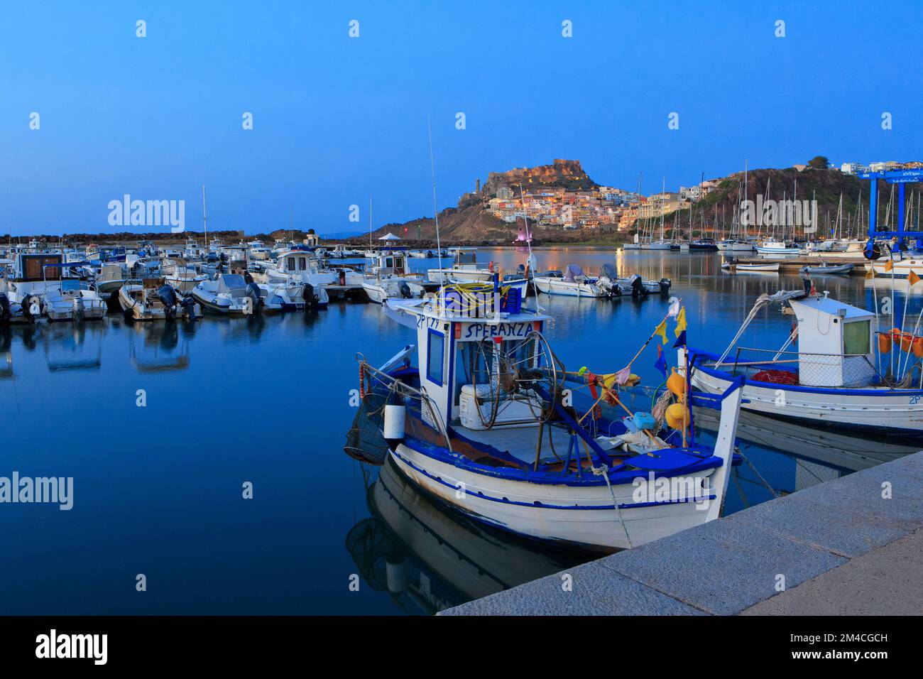 Traditionelle Fischerboote aus Holz, die in der Nähe der Burg Doria und der Kathedrale von Castelsardo (Provinz Sassari) auf der Insel Sardinien, Italien, festgemacht sind Stockfoto