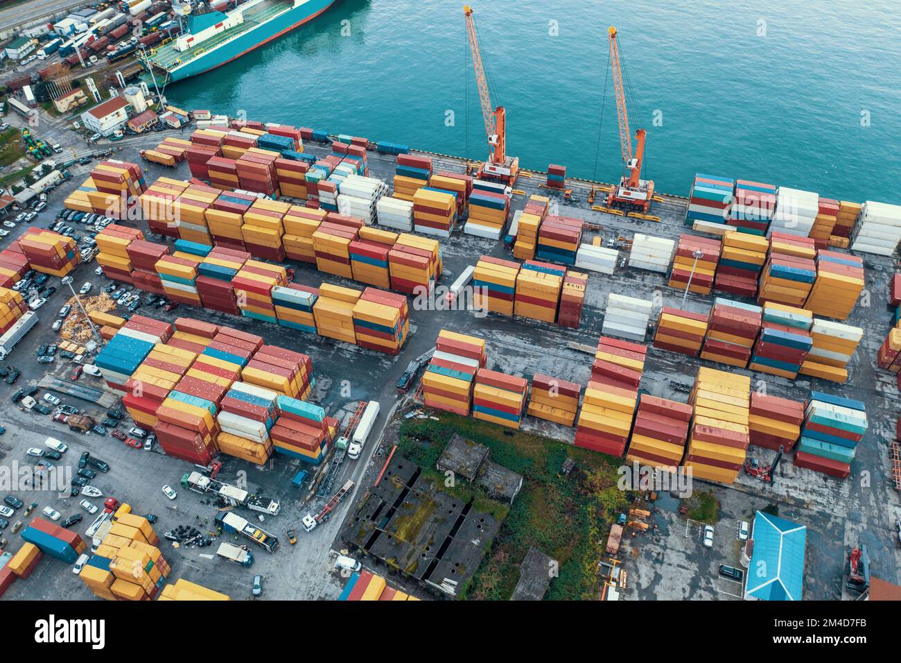 Containerhof im Frachtlogistikhafen. Frachtverkehr und globaler Versand. Containerkräne und Kisten im Hafenterminal. Stockfoto
