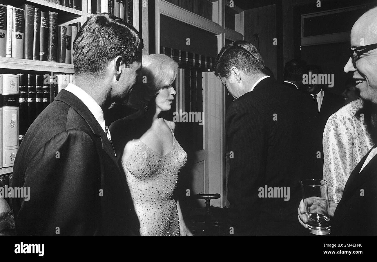 Marilyn Monroe von der U.S. Generalstaatsanwalt Robert F. Kennedy, Präsident John F. Kennedy und Arthur M. Schlesinger Jr. auf einer Privatfeier im Midtown Manhattan Penthouse von Arthur B. Krim und Mathilde Krim, die JFK 10 Tage vor seinem tatsächlichen Geburtstag feierten; Monroe hatte ihm in dieser Nacht in der Öffentlichkeit "Happy Birthday" gesungen; sie starb 77 Tage später. Stockfoto