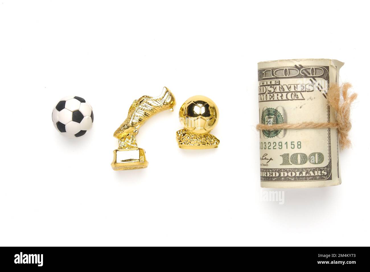 Ein Bild von Fußball, goldenem Stiefel und Ball mit gefälschtem Geld. Fußball Ruhm und Karriere Konzept. Stockfoto