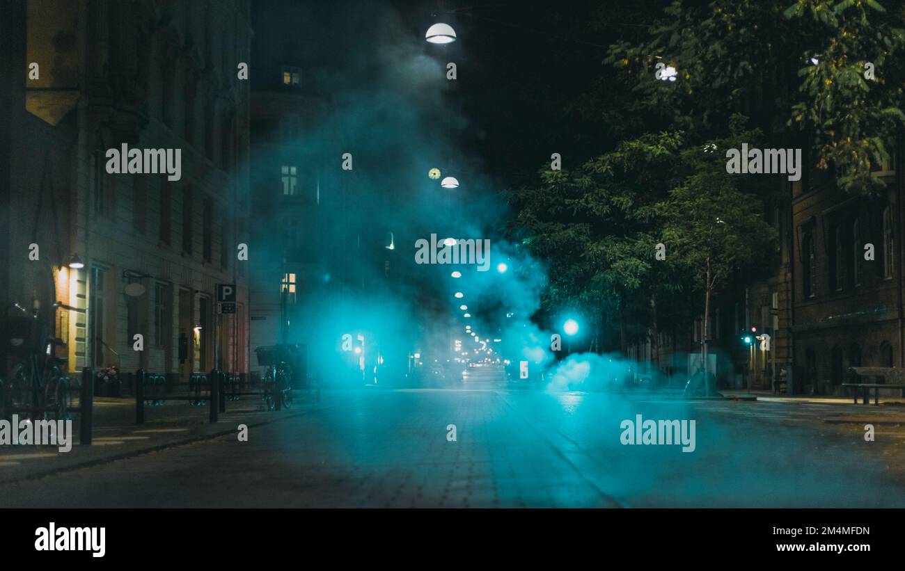 Blauer Dampf über der nächtlichen Stadtstraße Stockfoto