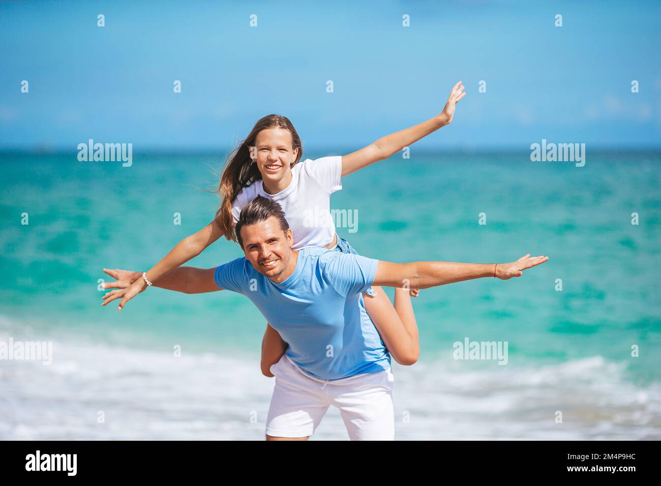 Die Familie von Vater und Tochter hat Spaß zusammen am Strand Stockfoto