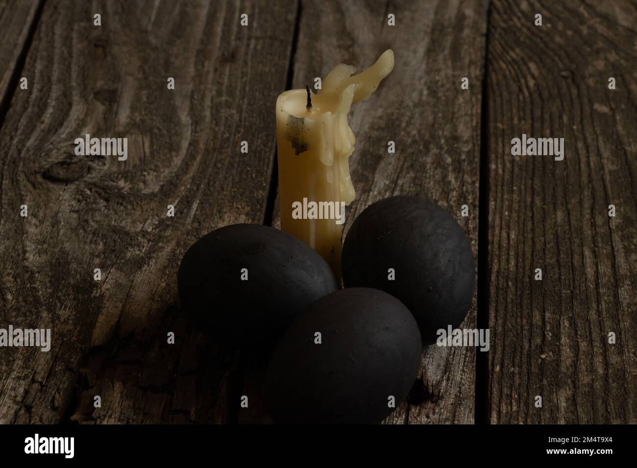 kirchenkerze und ostern stehen auf einem Holztisch am Quarantäne-ostertag Stockfoto