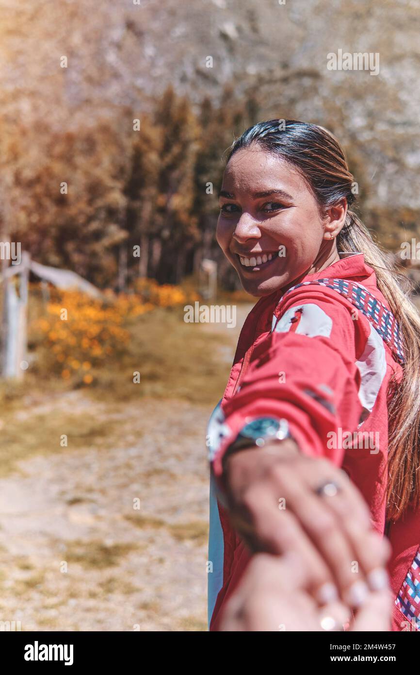 Nahaufnahme Young Woman hält einen Mann an der Hand und führt ihn durch die Natur im Freien. Konzept der Reiseliebe Stockfoto