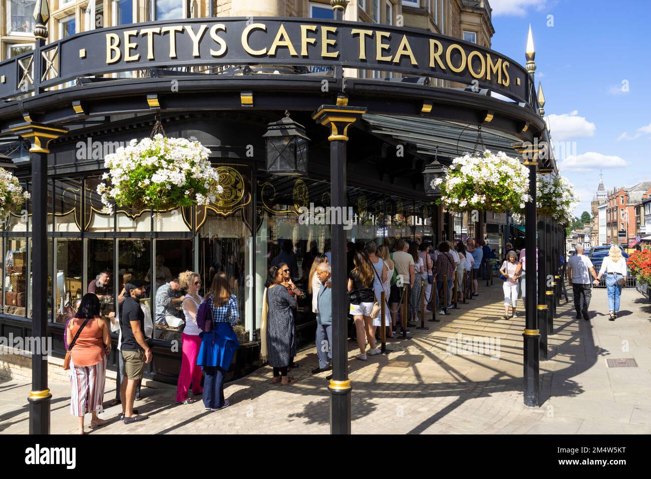 Harrogate Yorkshire Long Queue of People Outside Bettys Tea Rooms Harrogate Parliament Street Montpellier Quarter North Yorkshire England UK GB Europa Stockfoto