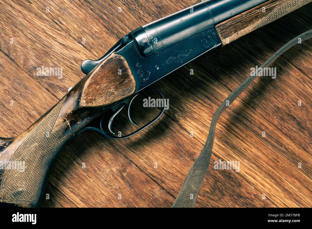 Antike 16-Gauge-Schrotflinte mit glatter Bohrung auf Holztisch. Stockfoto