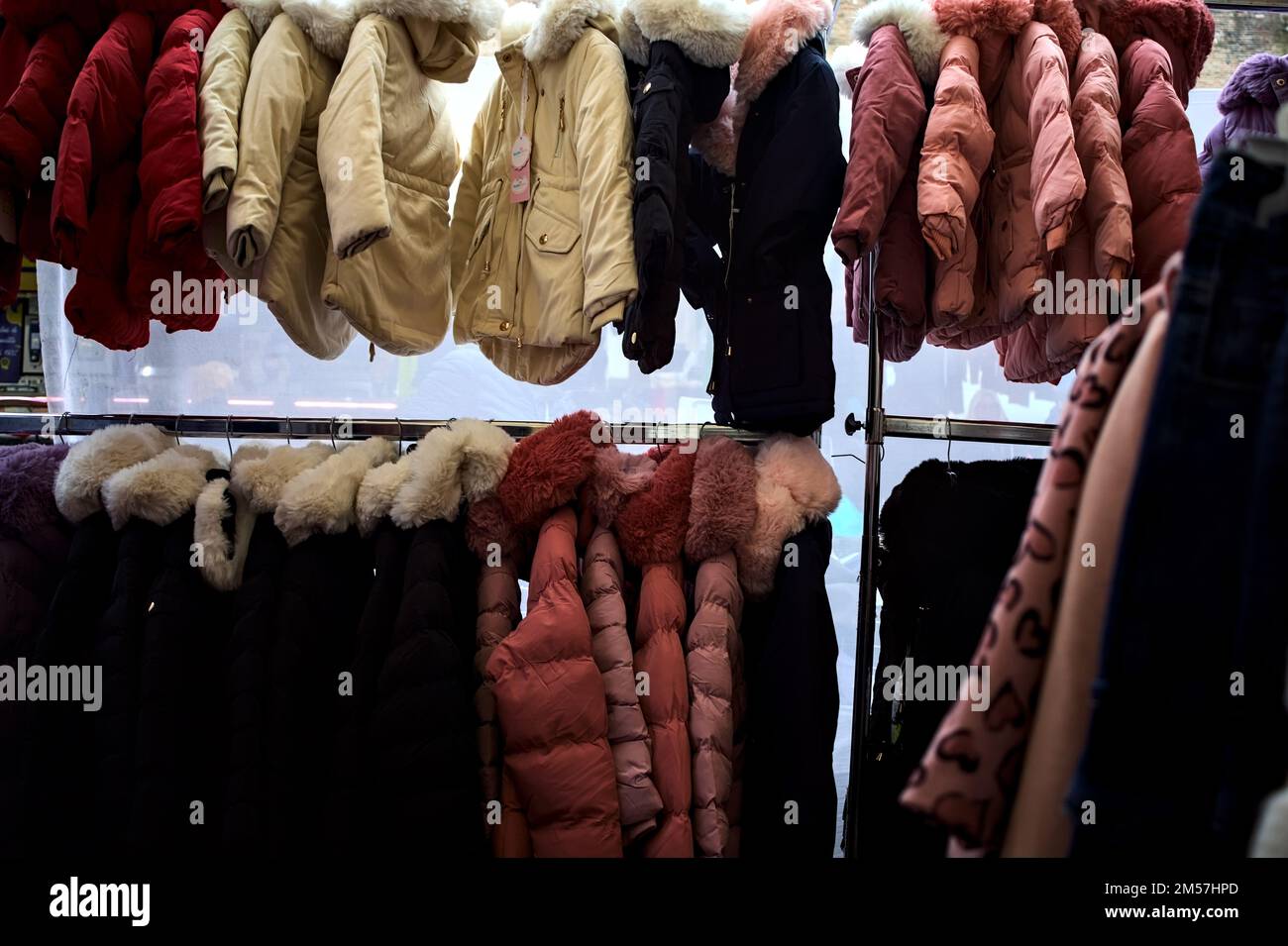 Kinderkleidung, die in einem Stall hängt, aus der Nähe gesehen Stockfoto