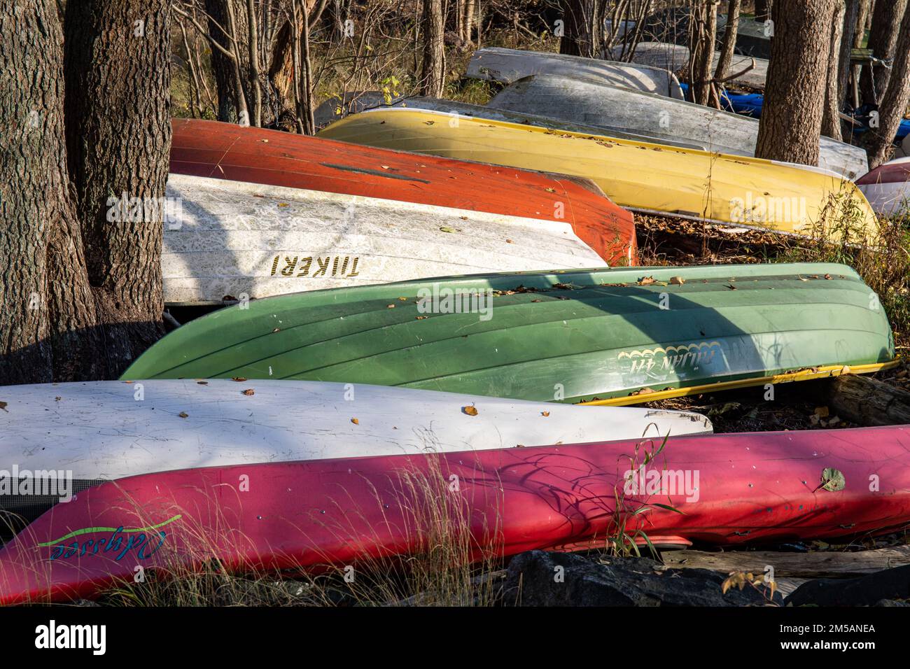 Ruderboote an Land, die verkehrt herum für den Winter im Bezirk Lehtisaari in Helsinki, Finnland, gelagert werden Stockfoto