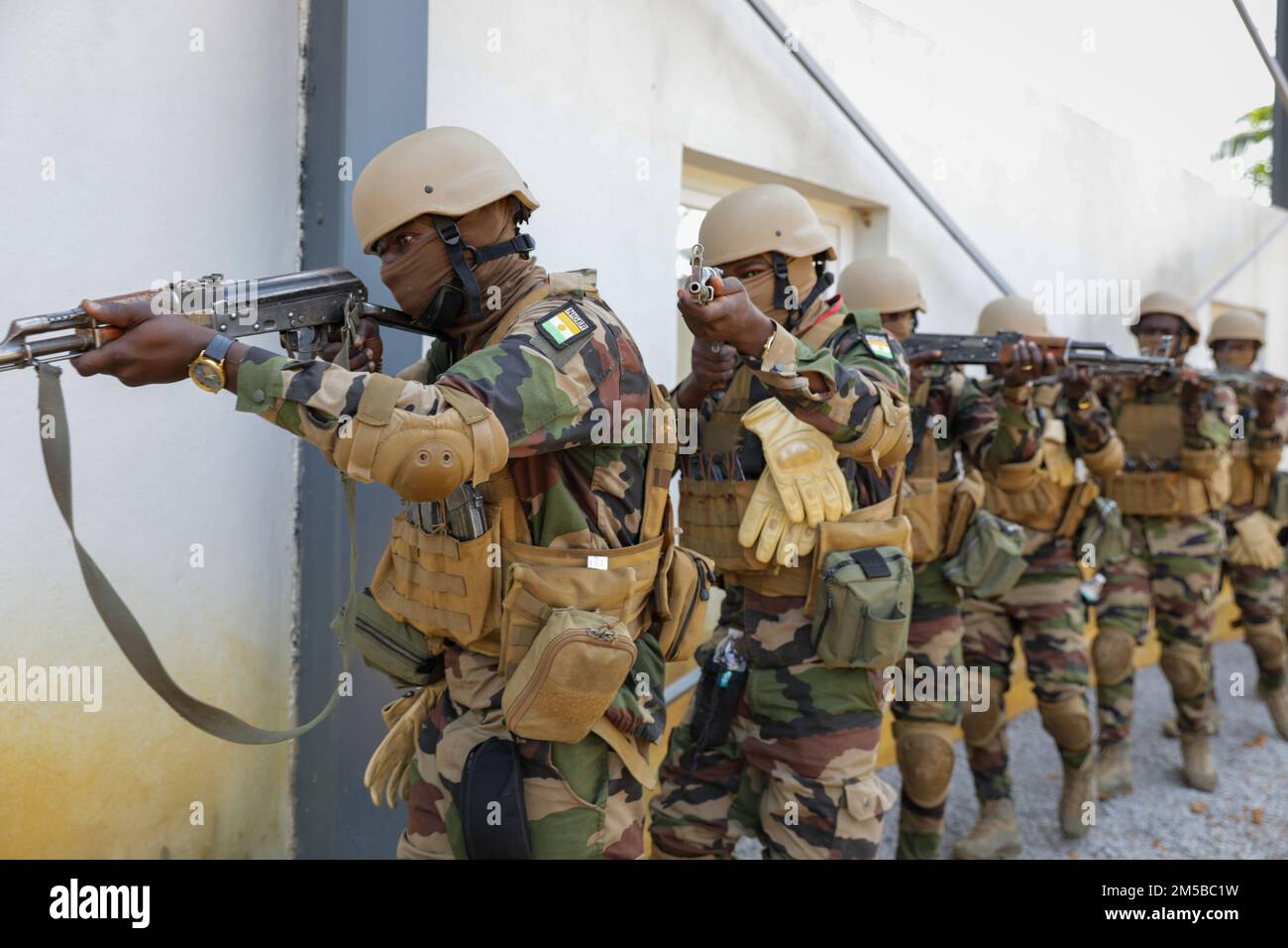 Nigerianische Streitkräfte betreten ein Gebäude während des Trainings im Nahkampf (CQB) in Flintlock, Côte d'Ivoire am 19. Februar 2022. Stlintlock umfasst verschiedene Trainingswege wie CQB, eine taktische Situation, die einen Waffenkampf aus nächster Nähe beinhaltet. Flintlock trägt dazu bei, die Fähigkeit von Verbündeten und Partnern zu stärken, gewalttätigem Extremismus entgegenzuwirken und Sicherheit für ihre Bevölkerung zu bieten. Stockfoto