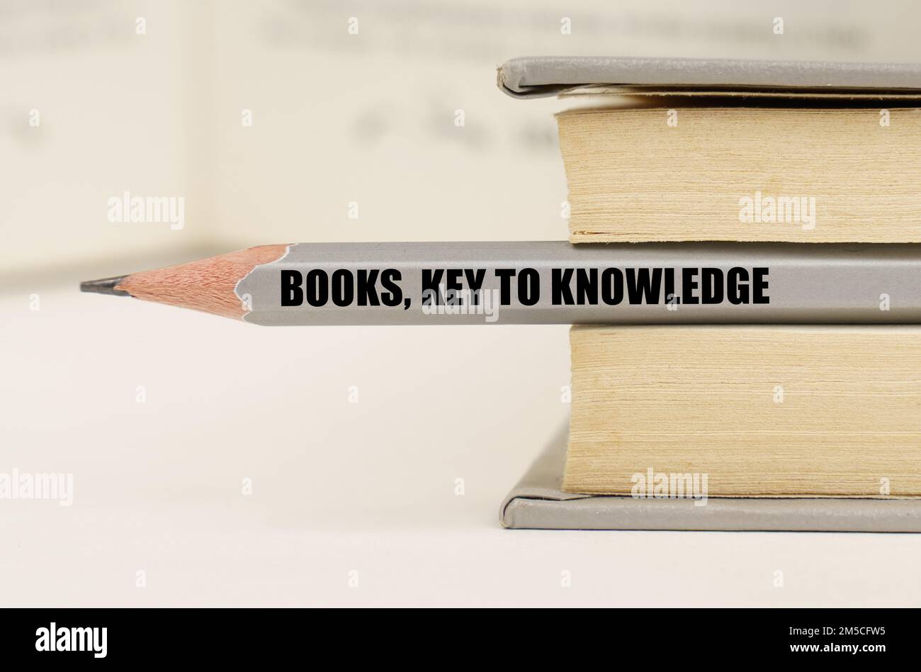 Bildungskonzept. Im Buch zwischen den Seiten liegt ein Bleistift mit der Inschrift - Bücher, Schlüssel zum Wissen Stockfoto