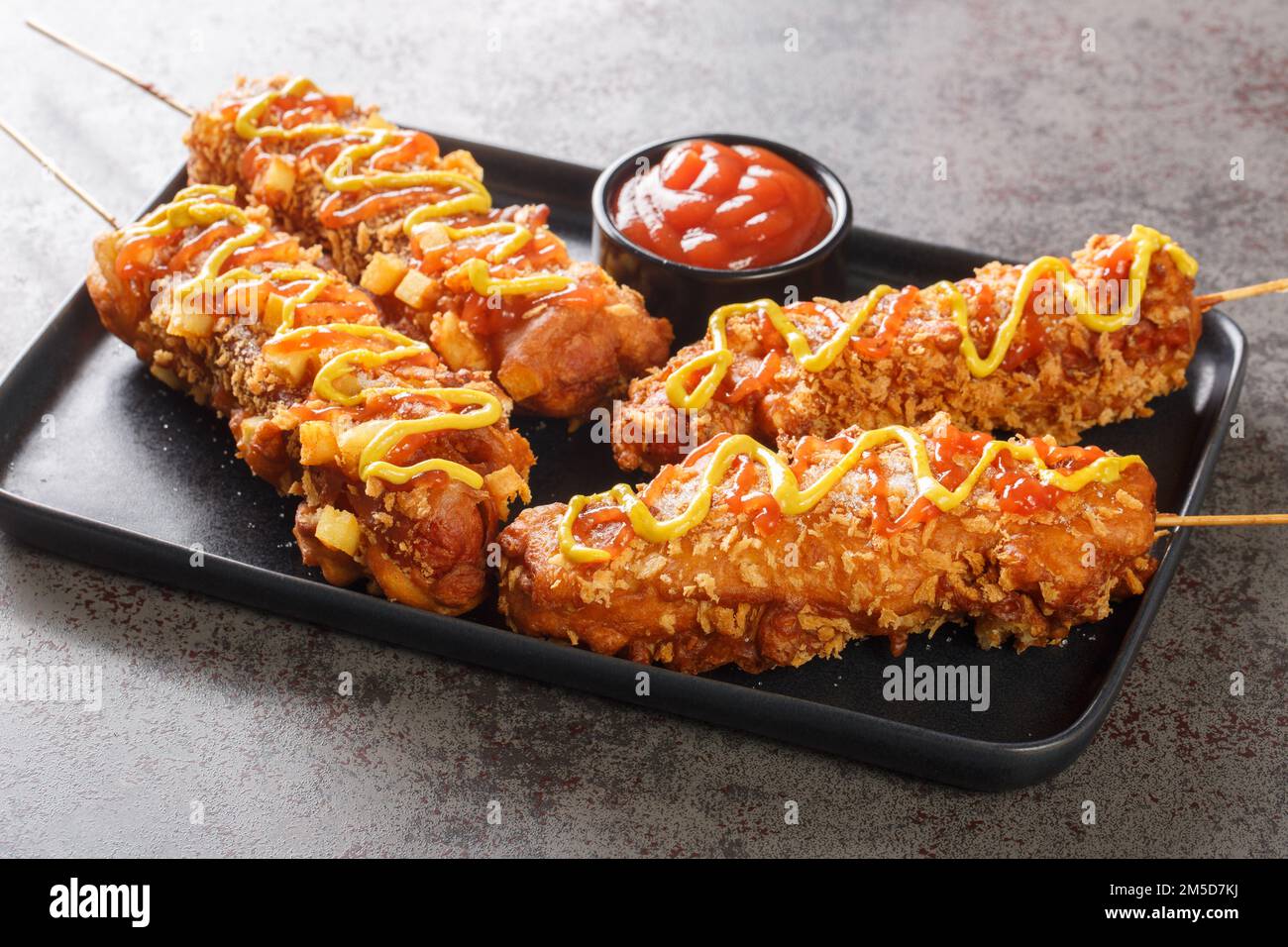 Koreanische Corn Dogs oder koreanische Hot Dogs sind beliebte lokale Street Food-Gerichte, die in der Regel aus Würstchen oder Mozzarella-Käse auf Stäben, frittierte Nahaufnahmen auf dem hergestellt werden Stockfoto