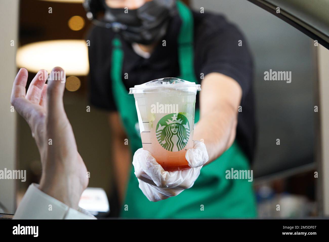 Starbucks Mitarbeiter geben Befehle am Drive-in. Limonade Erdbeere. Stockfoto