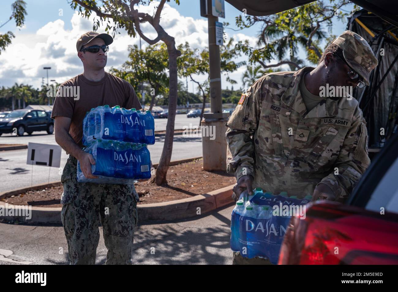 220307-N-ML137-1031 JOINT BASE PEARL HARBOR-HICKAM, Hawaii (7. März 2022) Machinist's Mate (Nuclear) 1. Class Zachary Shackelfold, zugewiesen an Pearl Harbor Naval Shipyard, Und Private First Class Darryl Reed, dem 84. Ingenieurbataillon, 523. Engineering Support Company, zugewiesen, lädt Fallwasser in ein Auto zur Unterstützung der Bewohner von Joint Base Pearl Harbor-Hickam (JBPHH). Die USA Navy arbeitet eng mit dem Hawaii Department of Health zusammen Environmental Protection Agency und den USA Armee, um sauberes Trinkwasser für die Wohngemeinden der Joint Base Pearl Harbor-Hickam wiederherzustellen. Für de Stockfoto