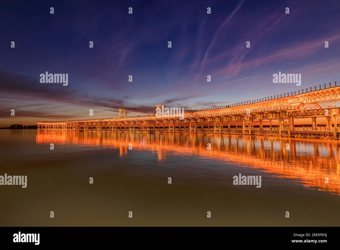 Bergbaupier, bekannt als Tinto Dock 'Muelle del Tinto' bei Nacht. Dies ist eine der Überreste, die die Engländer in Huelva hinterlassen haben. Stockfoto